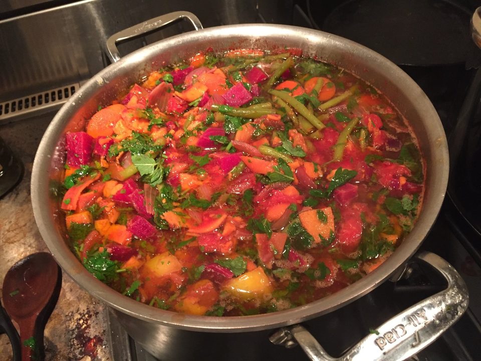 A large pot of vegetable stew with beets, carrots and green beans